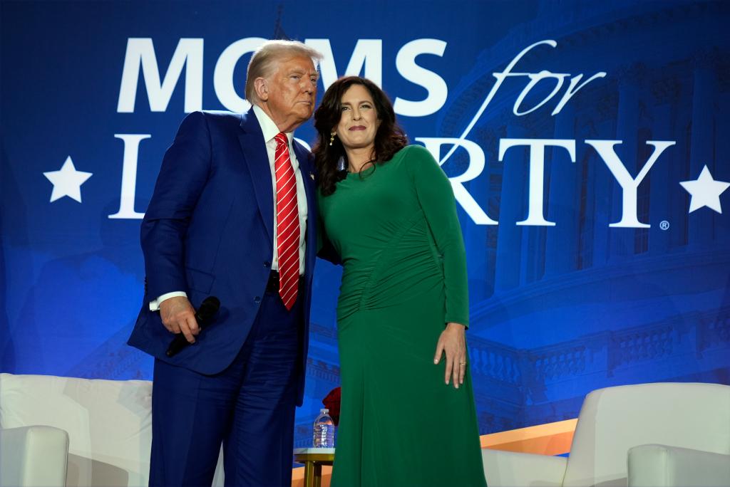 Republican presidential nominee former President Donald Trump stands with Moms for Liberty co-founder Tiffany Justice during an event at the group's annual convention in Washington, Friday, Aug. 30, 2024. 