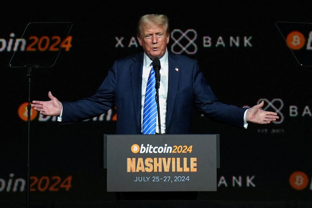 Former U.S. President Donald Trump gesturing at the Bitcoin 2024 event in Nashville while promoting his family's upcoming cryptocurrency platform.