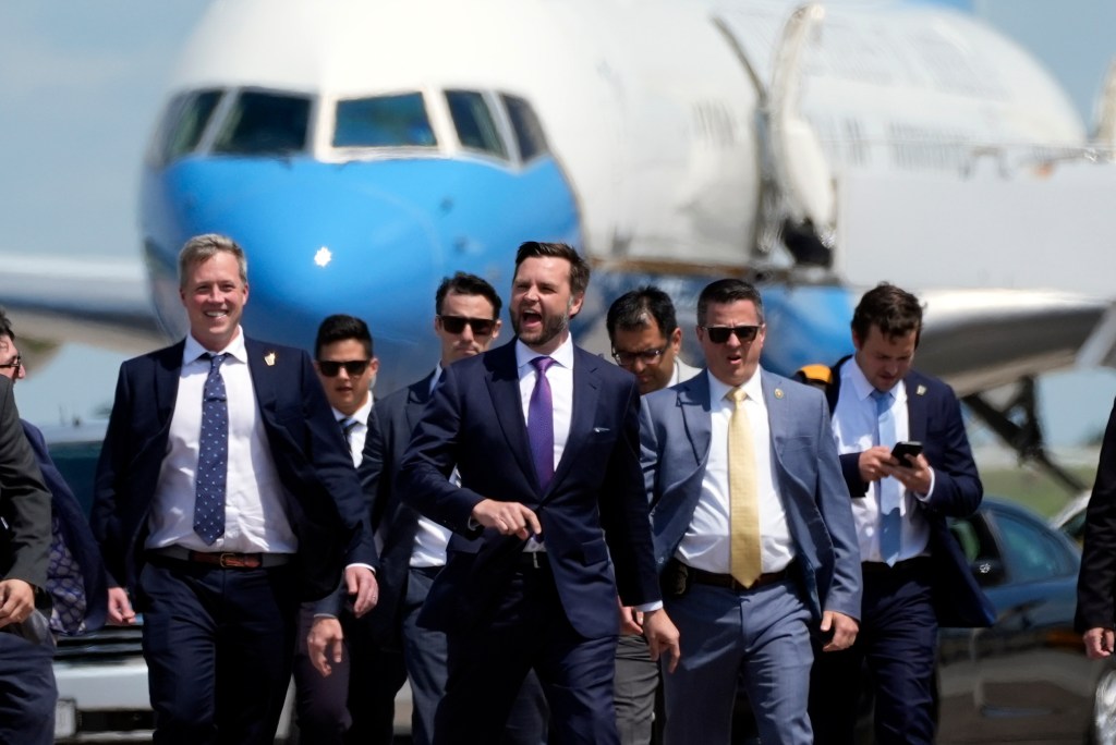 Republican vice presidential nominee Sen. JD Vance walks back from looking at Air Force Two at Chippewa Valley Regional Airport in Wisconsin.