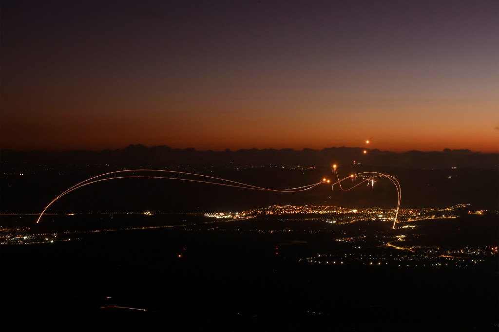 Rockets fired from southern Lebanon are intercepted by Israel's Iron Dome over the Upper Galilee region on August 23.