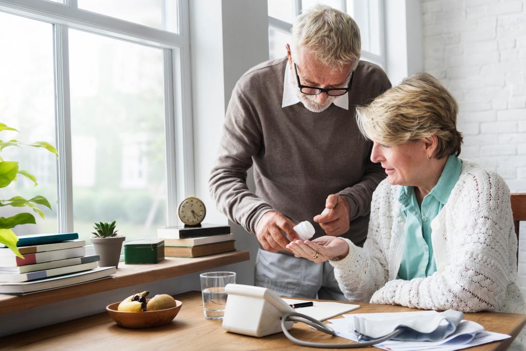 Senior adult taking medication