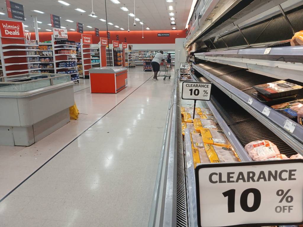 Shoppers browsing aisles during a clearance sale at the Winn-Dixie store in Deltona, set to transform into an Aldi by mid-September.