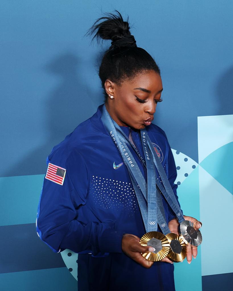 Simons Biles shows off her beautiful new medals to add to the collection. 