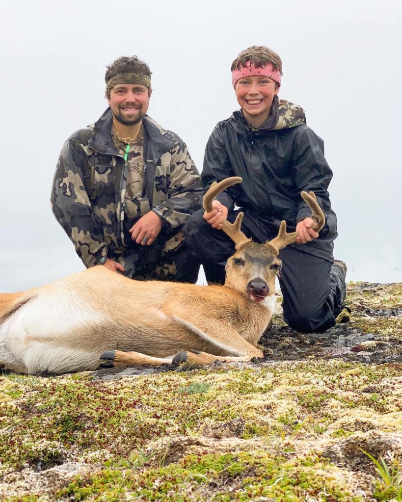 Tripp Johnston and his father posing with a deer during a hunting trip in Alaska