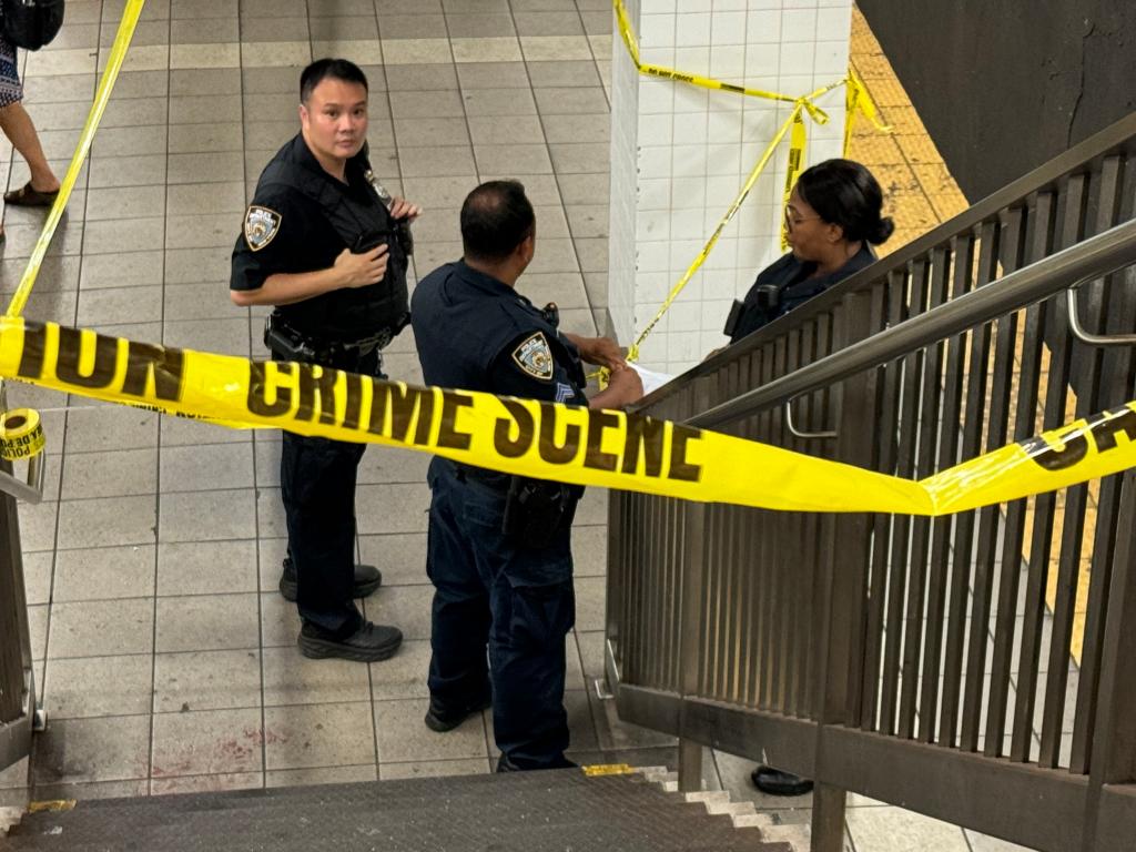 NYPD officers at the scene of a fatal subway strike in Queens. 