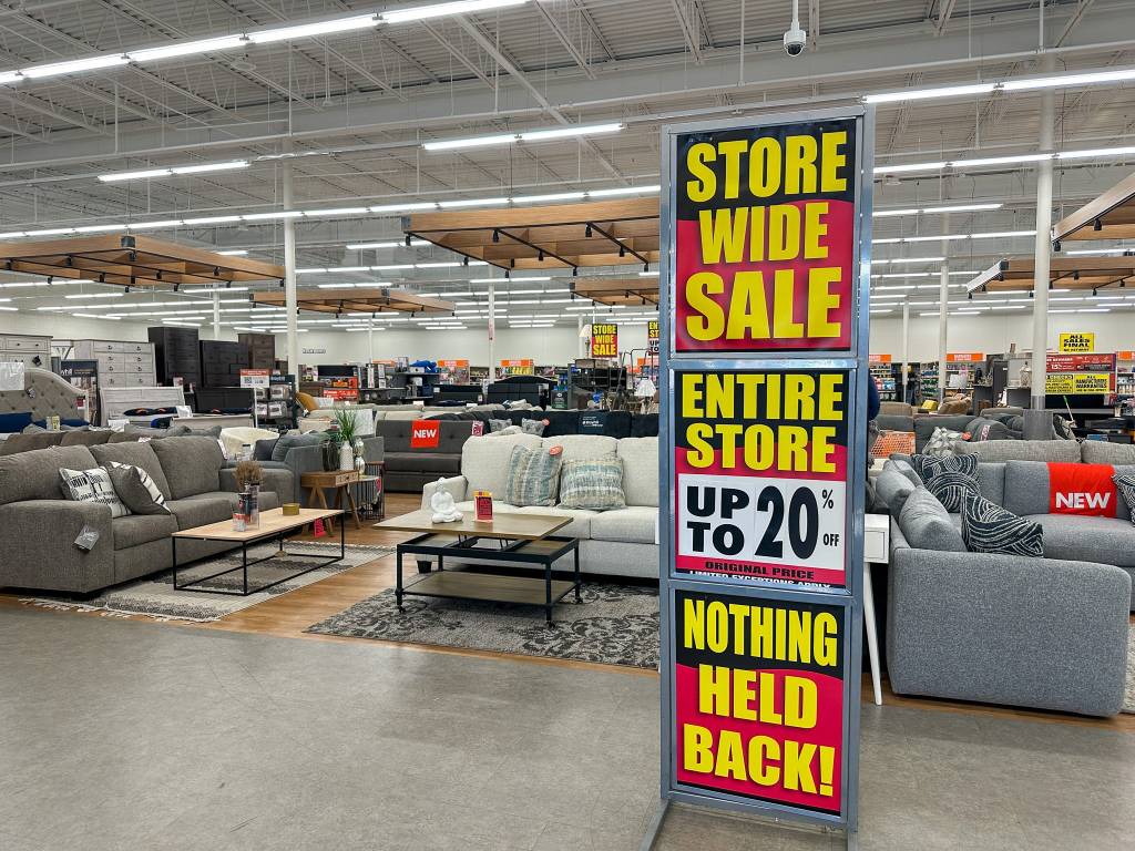 A Big Lots store preparing to close with a sign offering up to 20% off some items.