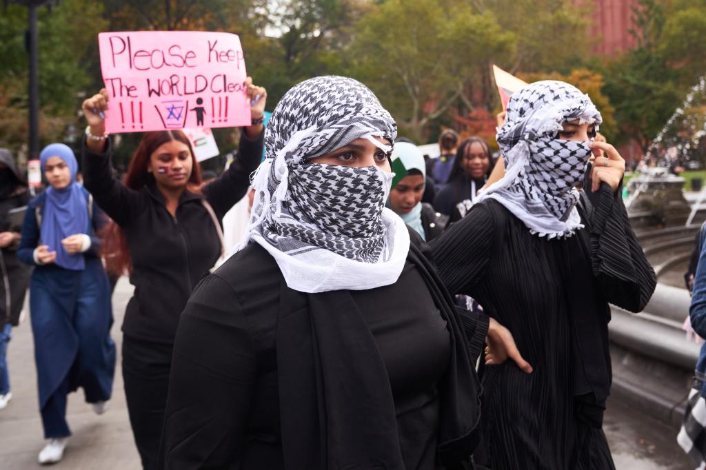 Ama Lou among a group of students, possibly from Urban Assembly Institute, participating in pro-Palestinian walkout at Washington Square Park, New York, holding anti-Israel posters