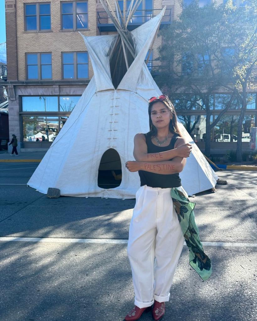 Tokata Iron Eyes standing in front of a teepee in October 2023