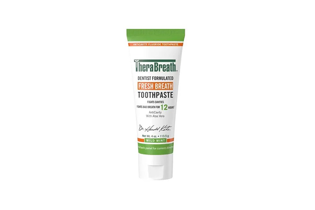 A white toothpaste tube with green and orange text