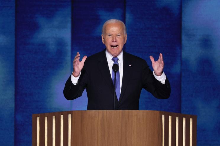 U.S. President Joe Biden speaking at the Democratic National Convention in Chicago, with his hands up, on August 19, 2024.