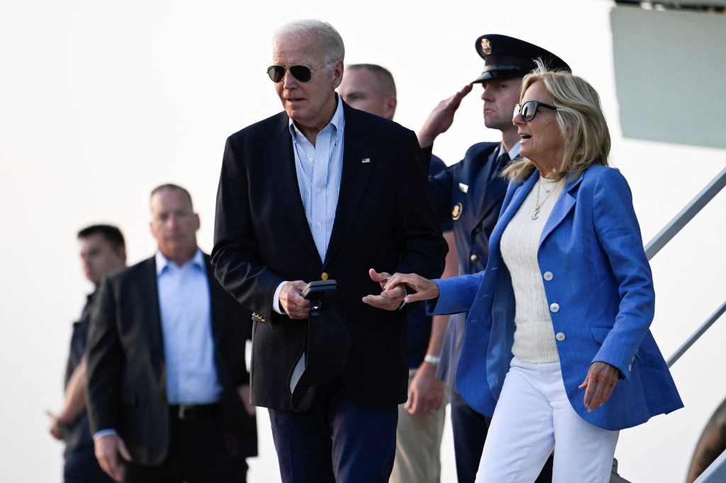 President Joe Biden lends a hand to first lady Jill Biden as they disembark from Air Force One at Dover Air Force Base prior to departure for Rehoboth Beach in Delaware, U.S., August 25, 2024. 