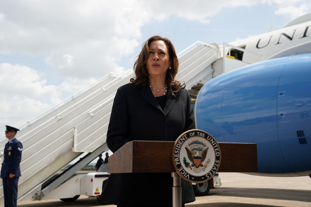 U.S. Vice President Kamala Harris speaking at a podium about detained individuals' release at George Bush Intercontinental Airport in Houston, Texas.