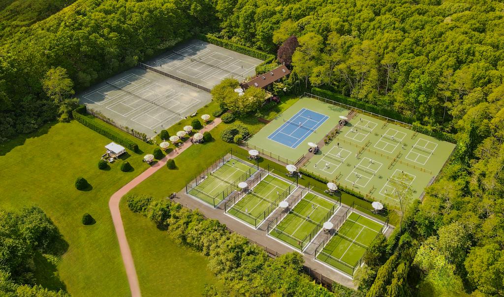 Tennis courts and trees with a path at the US Open Racquet Club