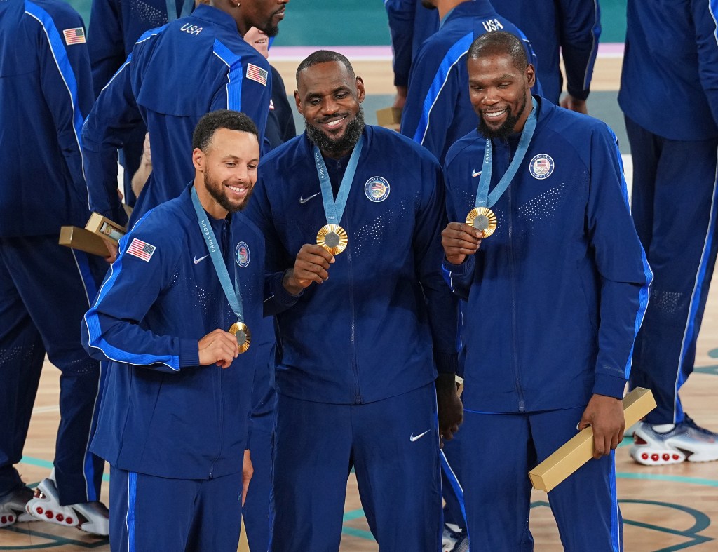 (From left) Steph Curry, LeBron James and Kevin Durant celebrate with their gold medals.