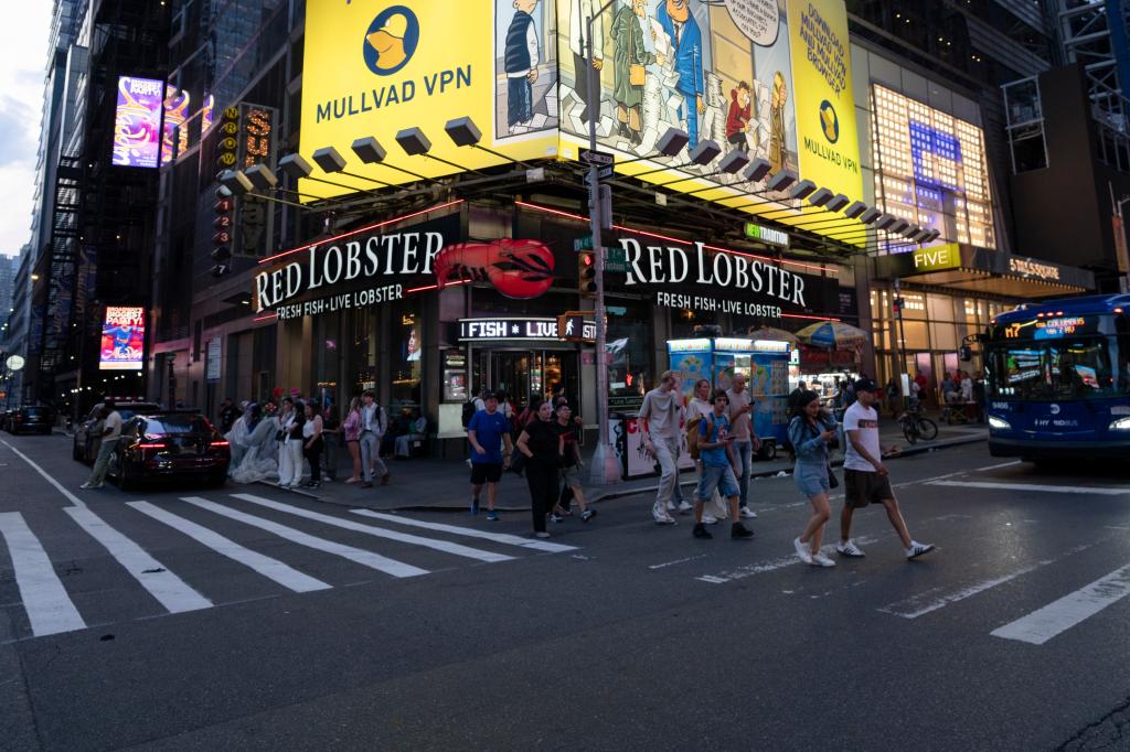 Exterior view of a Red Lobster restaurant in Times Square, New York City with people crossing the street.