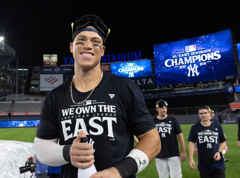 New York Yankees center fielder Aaron Judge #99 celebrates on the field after defeating the Baltimore Orioles.