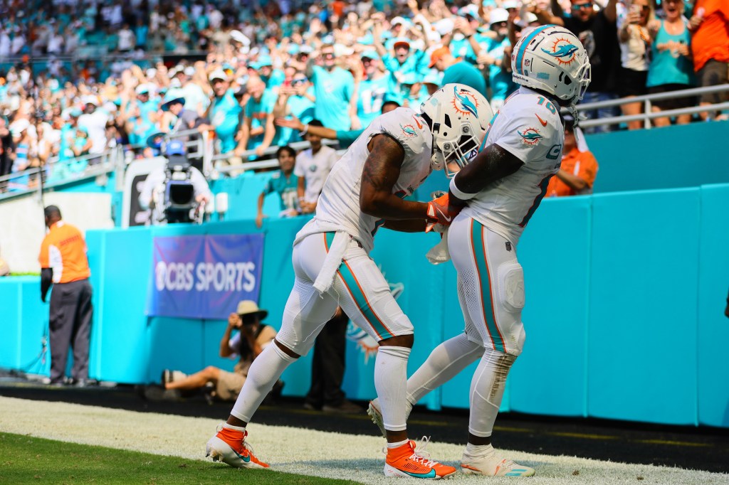 Tyreek Hill (r.) is joined by Dolphins teammate Jaylen Waddle (l.) in his handcuff celebration on Sept. 8, 2024.