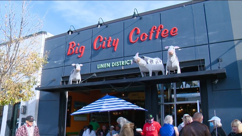 Big City Coffee storefront with cow statues outside