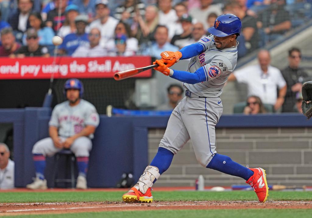 Mets shortstop Francisco Lindor (12) hits a home run against the Toronto Blue Jays during the ninth inning at Rogers Centre on Sept. 11, 2024.