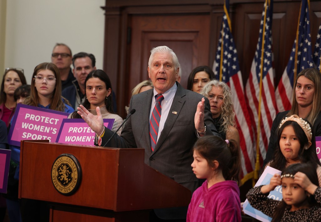 Nassau County Executive Bruce Blakeman standing at a podium, announcing a plan at a press conference with children at the Theodore Roosevelt Building in Mineola, Long Island, NY