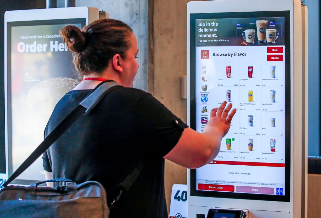 A woman placing an order at a digital kiosk during the grand opening of the new McDonald's Corporation headquarters in Chicago, USA.