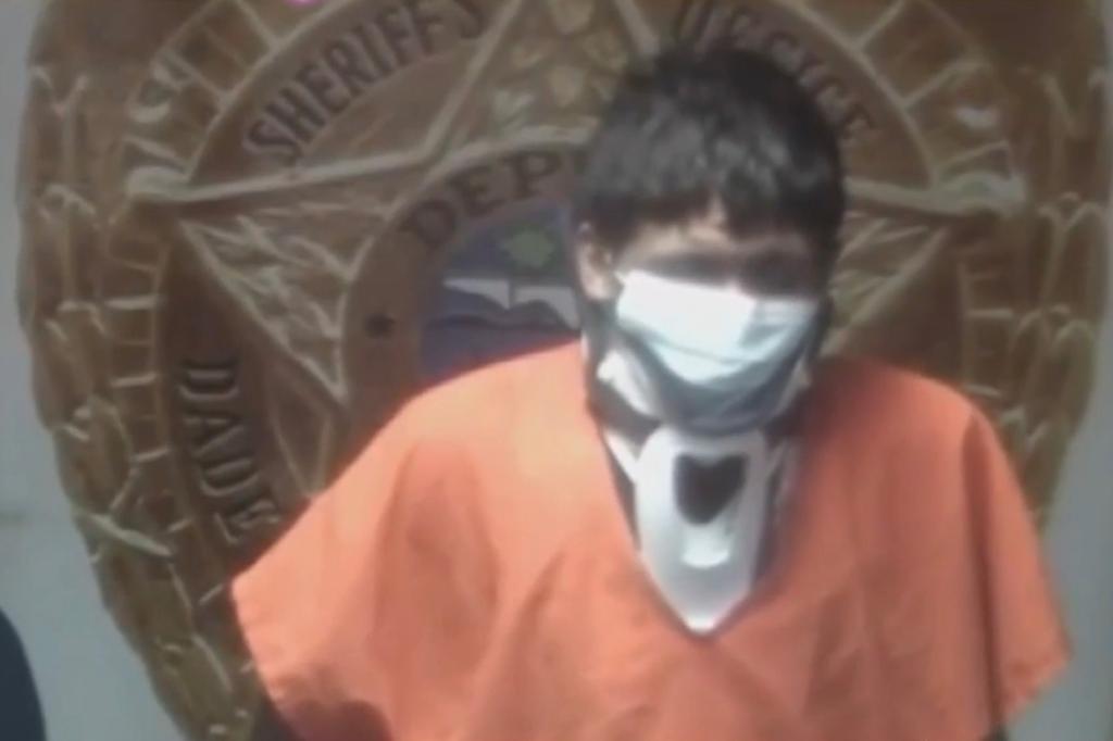 Erwin Rommel Recinos Zuniga, wearing a medical mask, appears in court wearing an orange jail shirt.