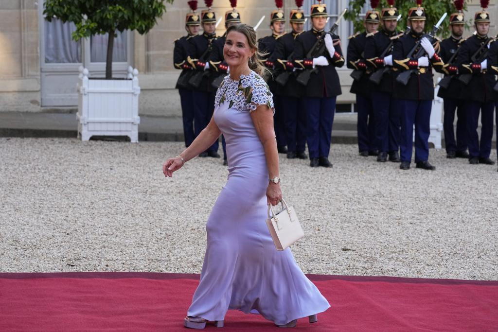 Melinda French Gates walking on a red carpet at the Elysee Palace in Paris for a Global Climate Finance summit