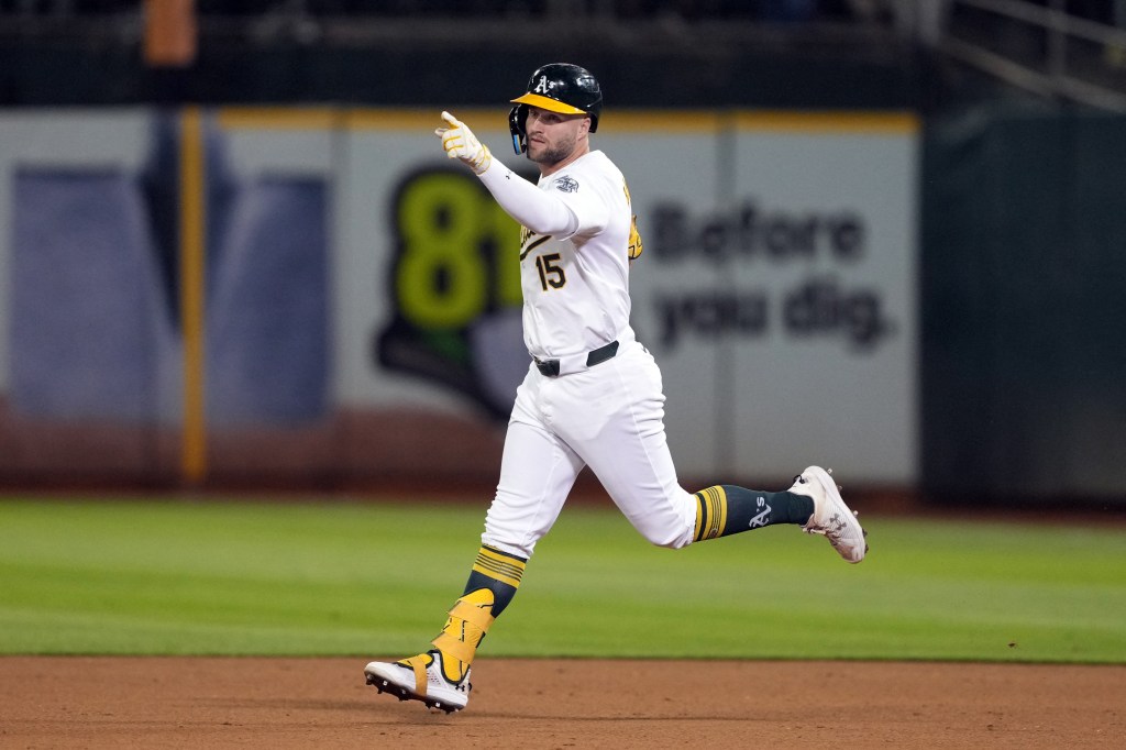 Oakland Athletics left fielder Seth Brown (15) gestures while rounding the bases after hitting a home run against the Detroit Tigers during the eleventh inning at Oakland-Alameda County Coliseum.