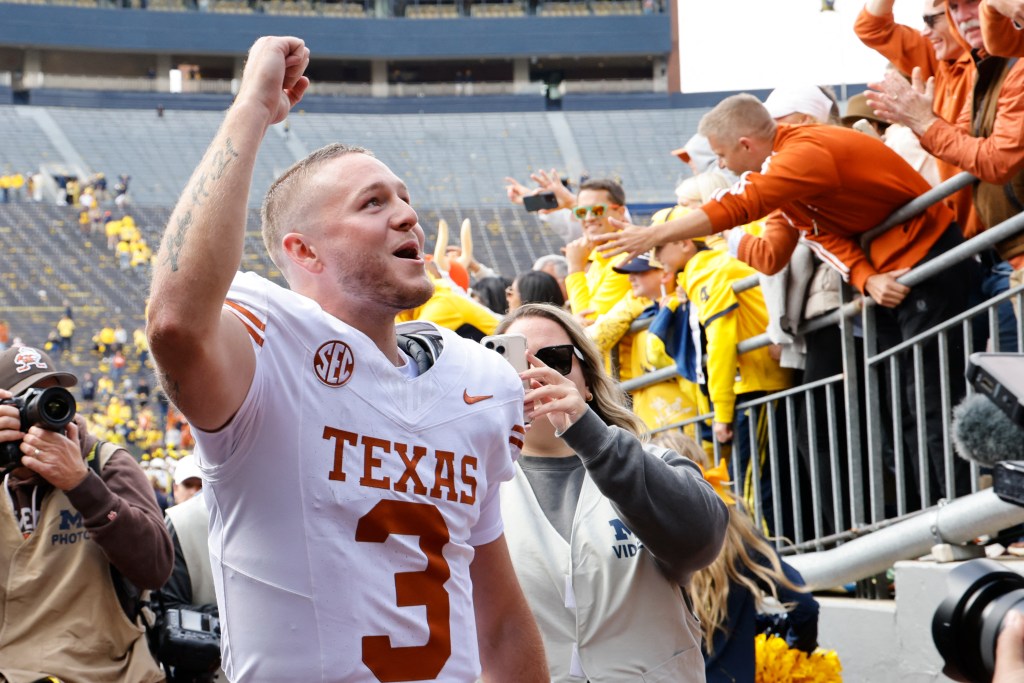 Texas Longhorns quarterback Quinn Ewers (3) celebrates after defeating the Michigan Wolverines at Michigan Stadium.