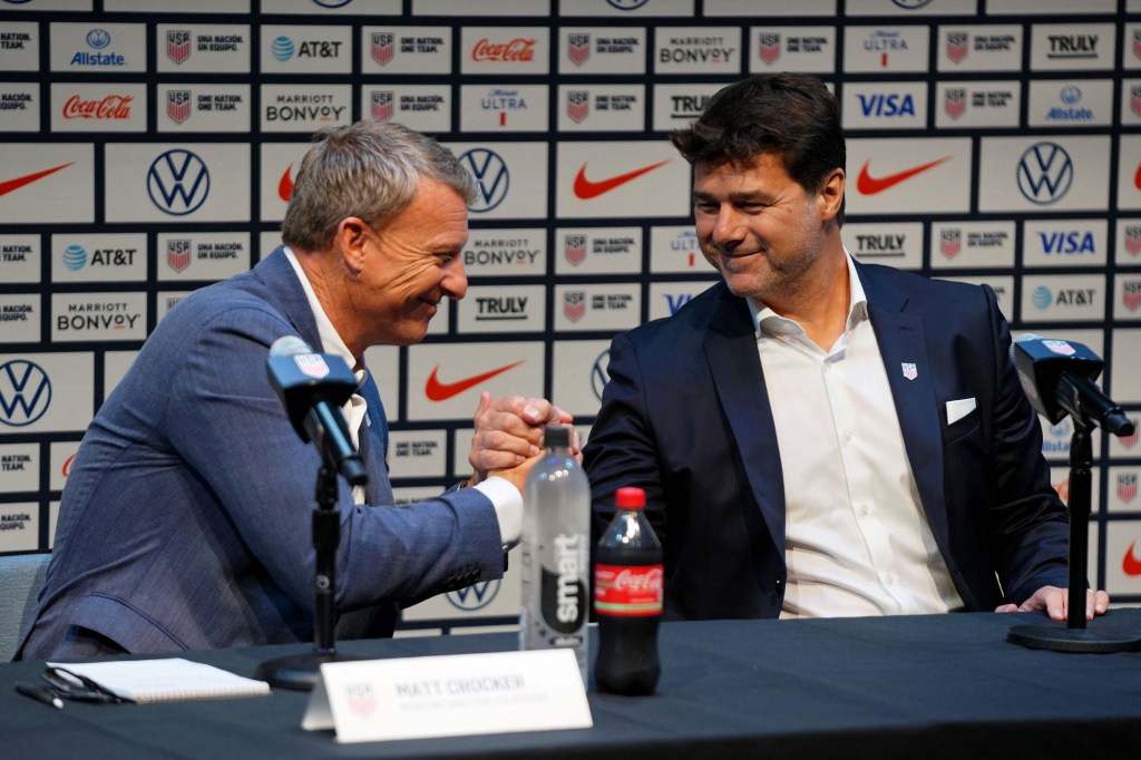 US Soccer sporting director Matt Crocker shakes hands with United States men's national team head coach Mauricio Pochettino talks to the media during a press conference introducing him as the new head coach for the United States men's national team at Warner Bros. Discovery Hudson Center. 