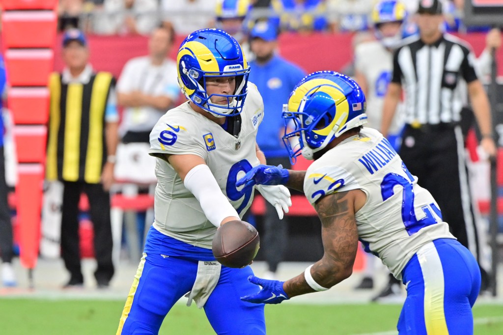 Los Angeles Rams quarterback Matthew Stafford (9) hands off to running back Kyren Williams (23) in the first half against the Arizona Cardinals at State Farm Stadium.