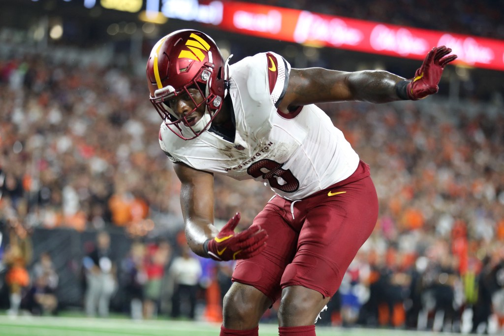 Washington Commanders running back Brian Robinson Jr. (8) celebrates a touchdown during the first quarter against the Cincinnati Bengals at Paycor Stadium. 