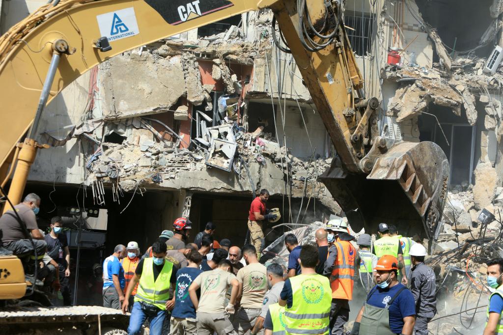 Rescuers sift through the rubble at the scene of an Israeli strike that targeted Beirut's southern suburbs a day earlier. 