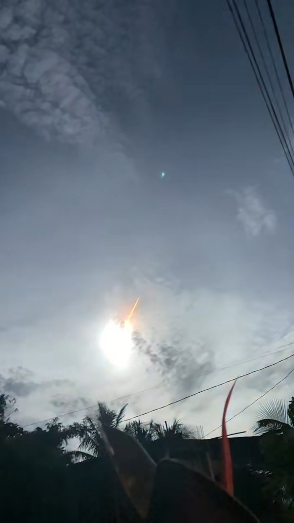 Image of the asteorid over the Philippines and palm trees.