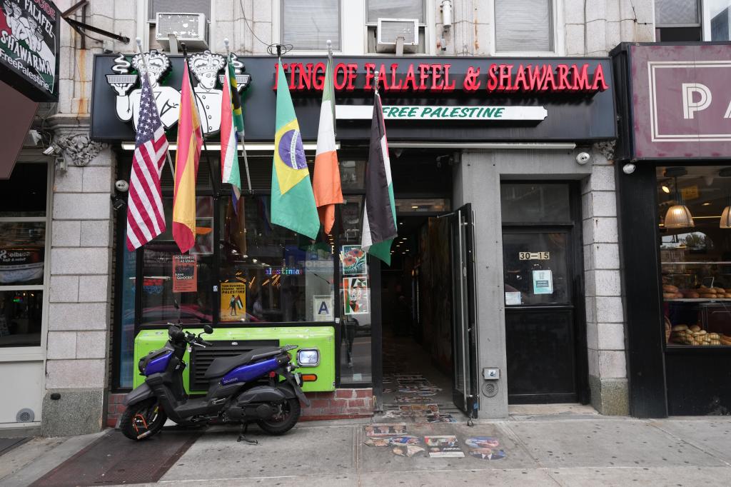 The King of Falafel and Shawarma has a "free Palestine" sign outside underneath the restaurant's name.