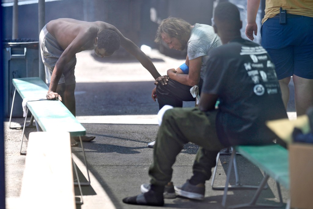 People at a cooling station outside of a homeless shelter in Phoenix on May 30, 2024.