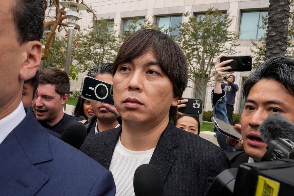 Ippei Mizuhara, center, the former interpreter for the Los Angeles Dodgers baseball player Shohei Ohtani, leaves federal court in Santa Ana, Calif., Tuesday, June 4, 2024