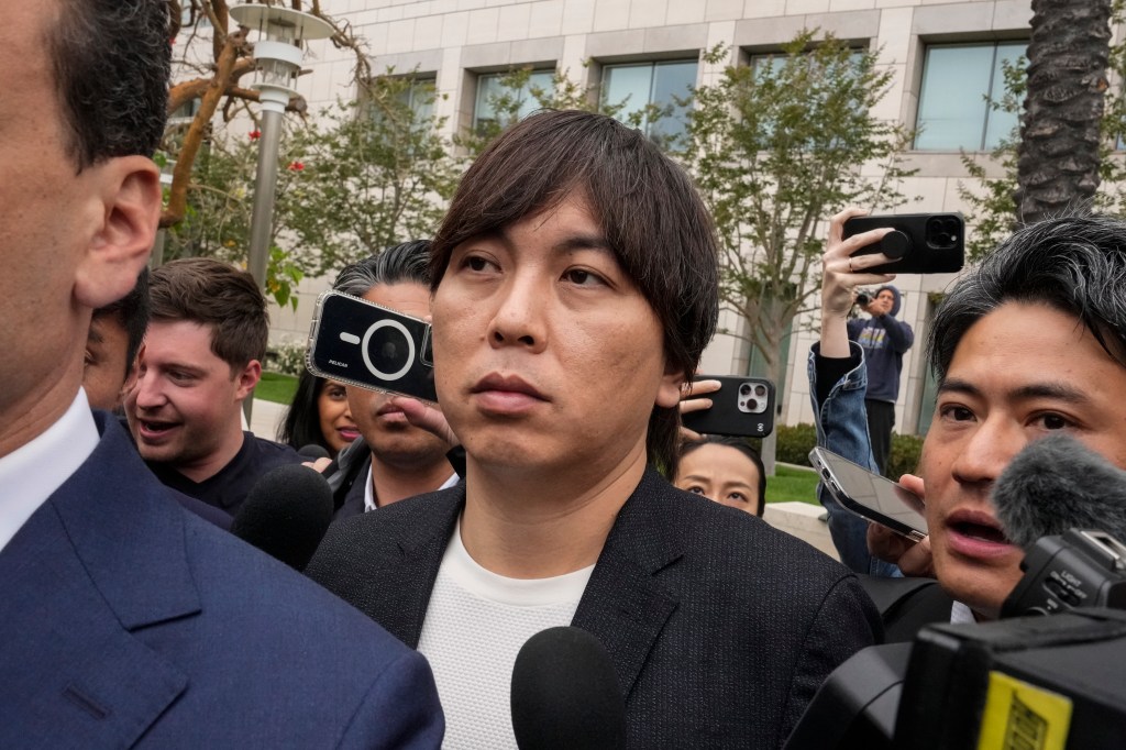 Ippei Mizuhara, center, the former interpreter for the Los Angeles Dodgers baseball player Shohei Ohtani, leaves federal court in Santa Ana, Calif., Tuesday, June 4, 2024