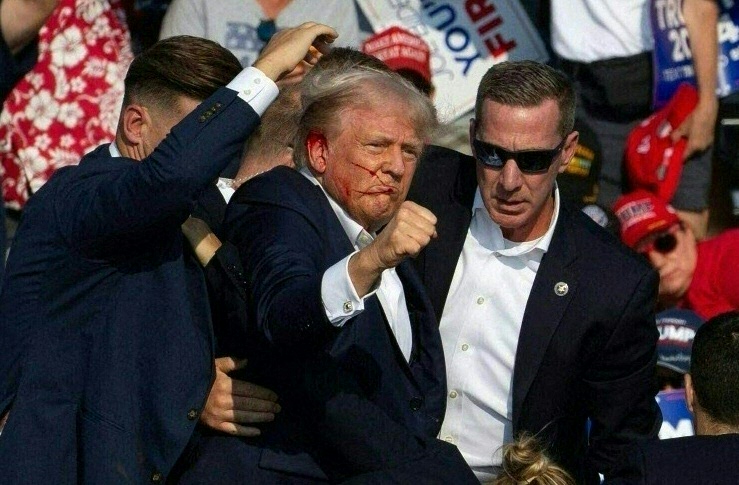 Republican candidate Donald Trump is seen with what appears to be blood on his face surrounded by secret service agents as he is taken off the stage at a campaign event at Butler Farm Show Inc. in Butler, Pennsylvania, July 13, 2024. 