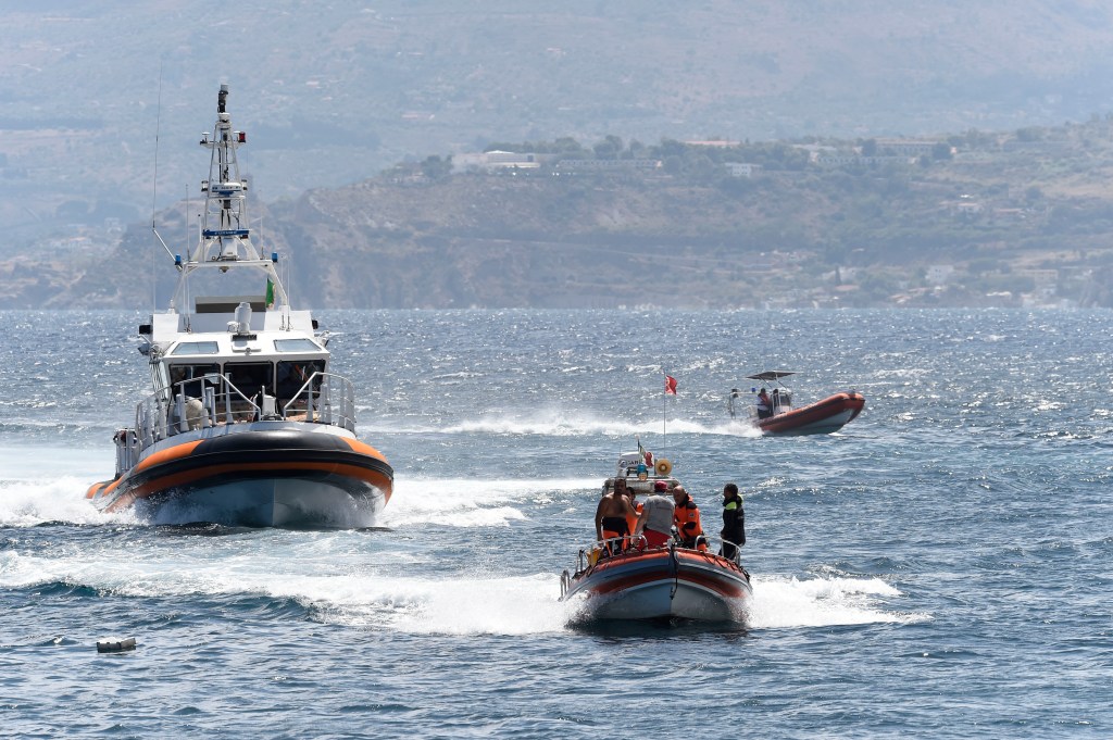 Emergency services and divers searching for the missing boat underwater in Porticello, southern Italy