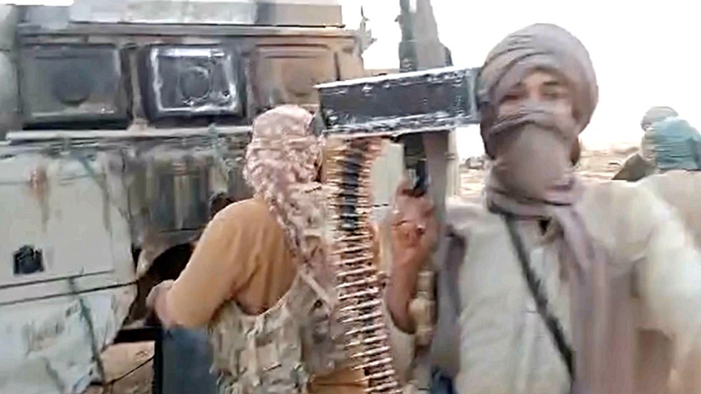 Tuareg rebel alliance fighters inspected a damaged vehicle allegedly used by Wagner mercenaries in July 2024.