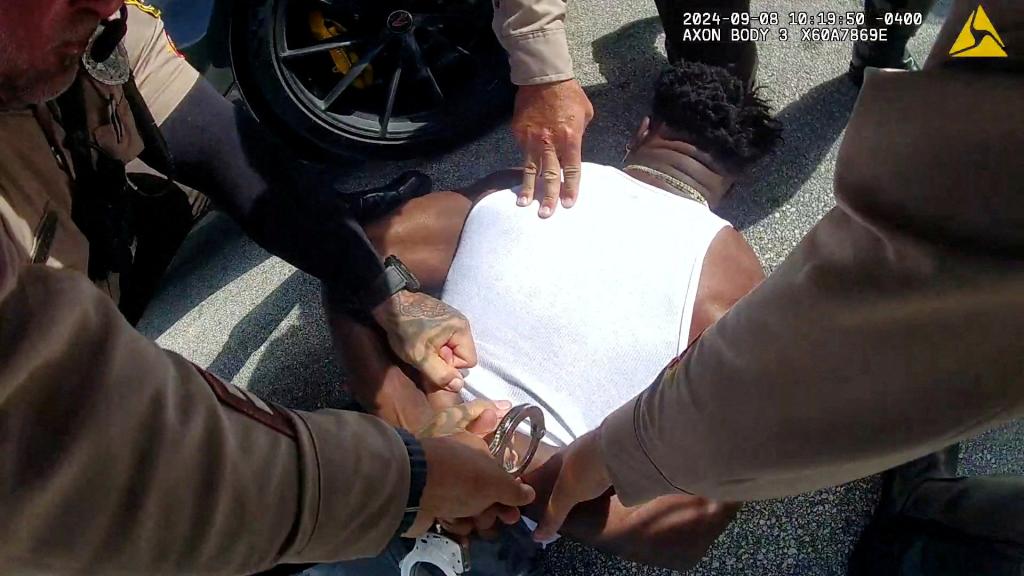 Miami Dolphins receiver Tyreek Hill is handcuffed after being forced from his vehicle by Miami-Dade Police Department officers in Miami, Florida, September 8, 2024 in a still image from police body camera video.   