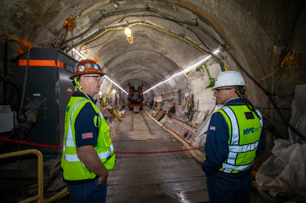 Men in safety vests and helmets working in a section of the Delaware Aqueduct, part of a major repair project in 2024.