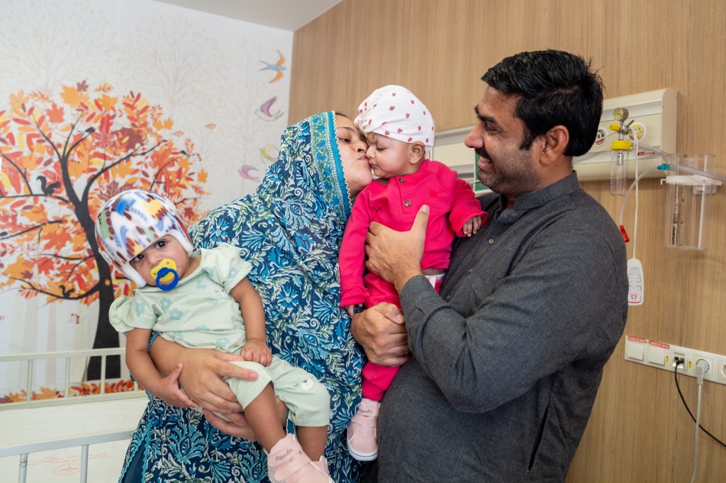 The newly-separated twins are pictured with their ecstatic parents in Turkey. 