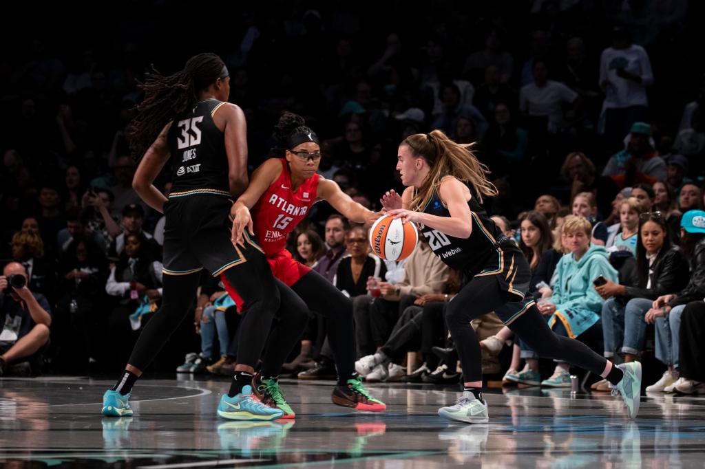 Sabrina Ionescu #20 of the New York Liberty drives against Allisha Gray #15 of the Atlanta Dream