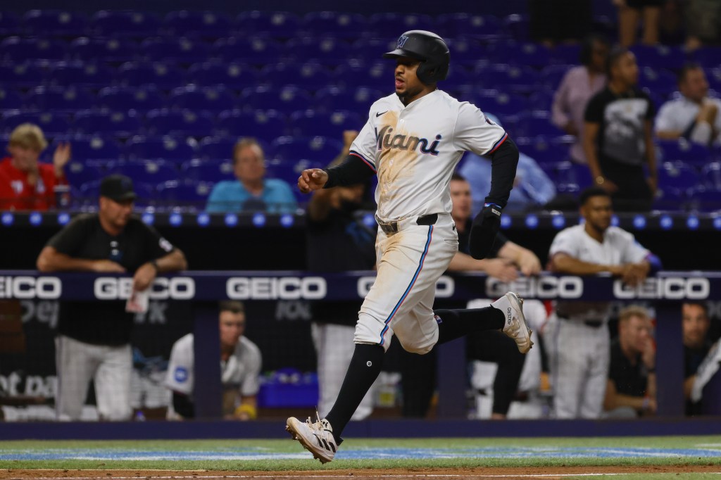 Miami Marlins shortstop Xavier Edwards (63) scores after an RBI single by first baseman Jake Burger (not pictured) against the Washington Nationals during the eighth inning at loanDepot Park. 