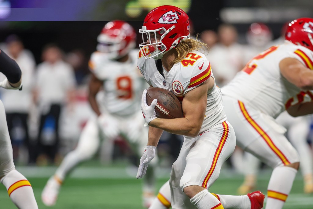 Kansas City Chiefs running back Carson Steele (42) runs the ball against the Atlanta Falcons in the first quarter at Mercedes-Benz Stadium.