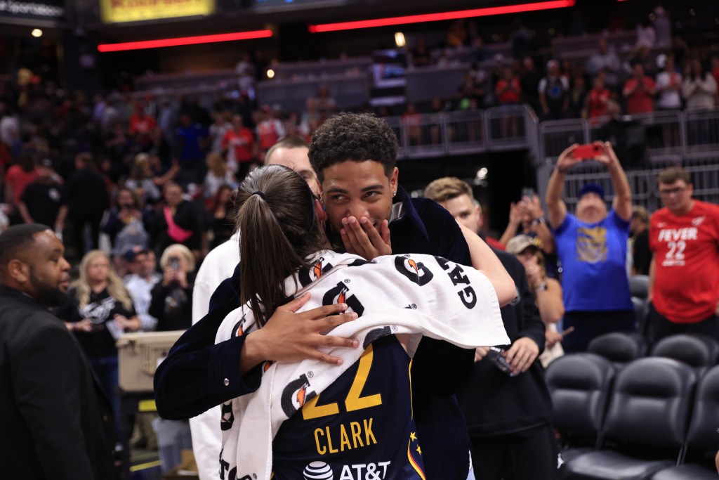 Tyrese Haliburton talks to Caitlin Clark #22 of the Indiana Fever after the game against the Los Angeles Sparks on September 4, 2024 at Gainbridge Fieldhouse in Indianapolis, Indiana.