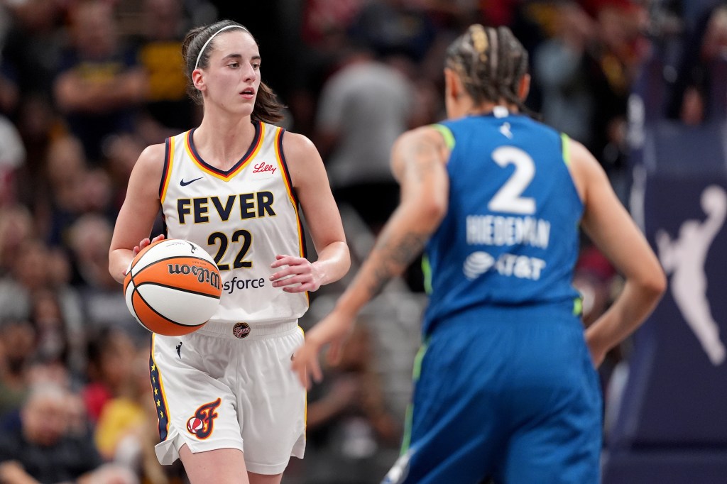 Caitlin Clark #22 of the Indiana Fever dribbles the ball up court against Natisha Hiedeman #2 of the Minnesota Lynx during the second half at Gainbridge Fieldhouse on September 06, 2024 in Indianapolis, Indiana. 