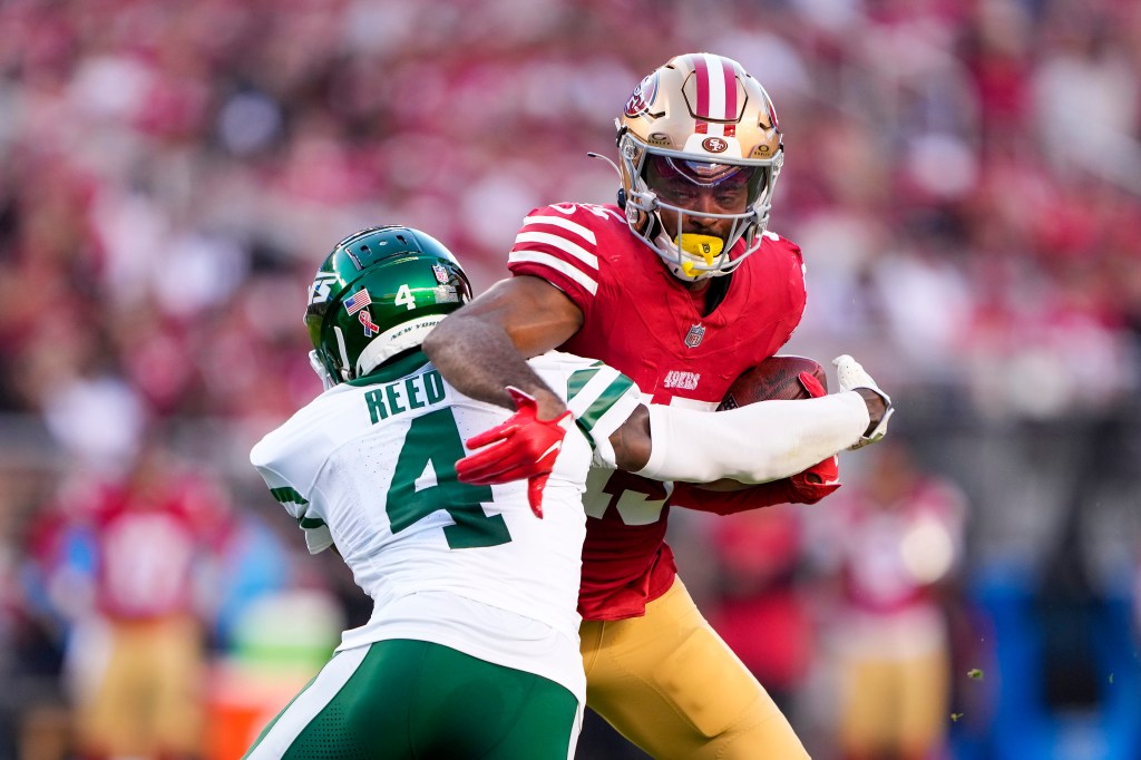 Wide receiver Jauan Jennings #15 of the San Francisco 49ers is tackled by cornerback D.J. Reed #4 of the New York Jets during the second quarter at Levi's Stadium on September 09, 2024 in Santa Clara, California. 